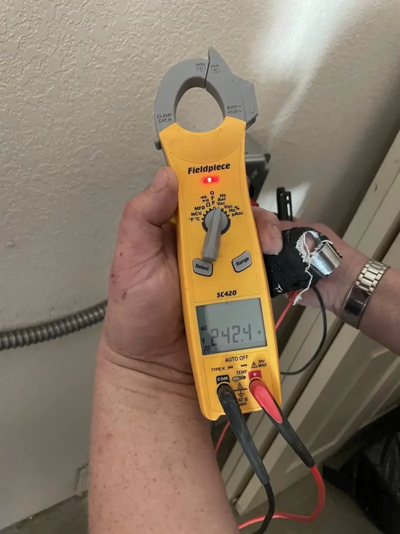 Voltage testing with clamp meter during Outlet Installation in Lake Shore